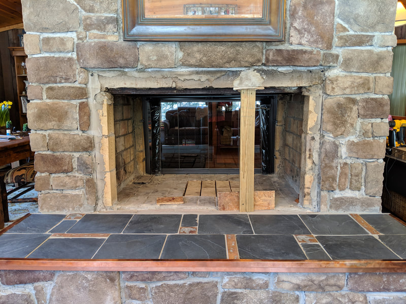 slate tile and copper edged fireplace hearth top